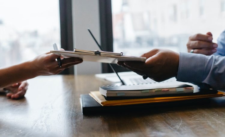 crop black job candidate passing resume to hr employee
