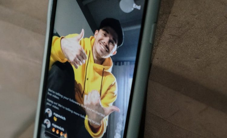 man in yellow hoodie sweater doing live in social media