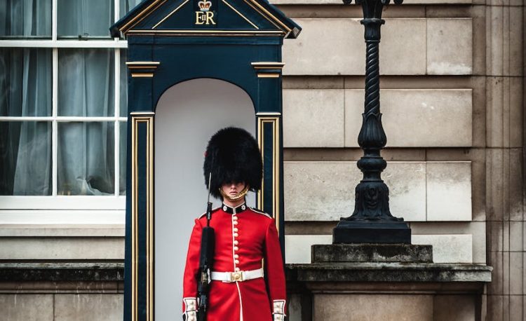 royal guard standing near lamp post