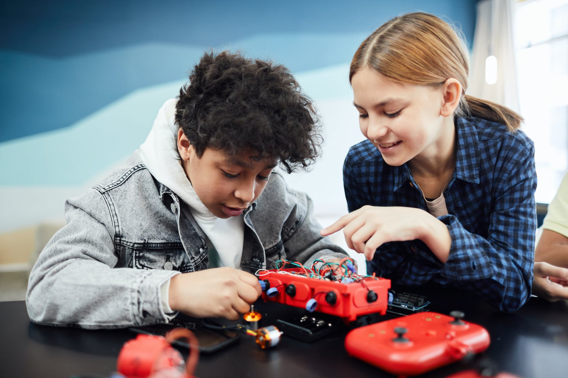 a boy and girl doing robotic project