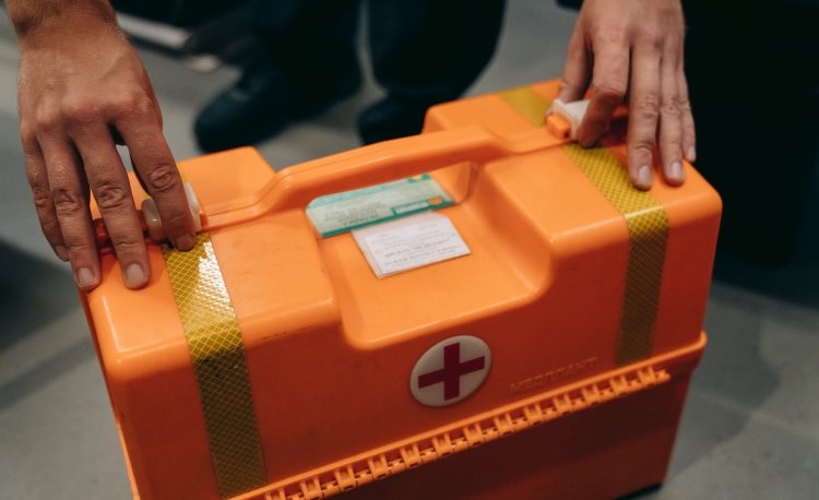 a person holding a first aid kit