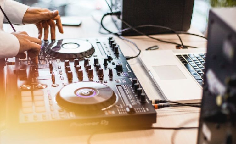 photo of person holding dj controller