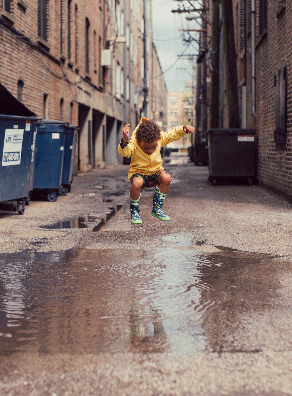 child jumping into body of water