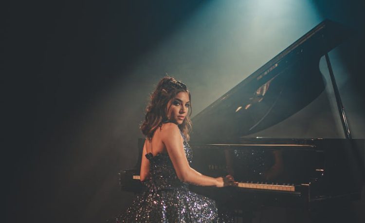 woman sitting near piano