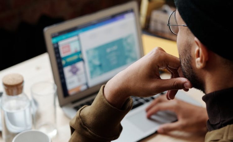 backview of man using laptop