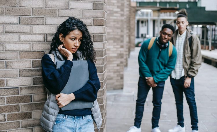 diverse classmates bullying hispanic student in university