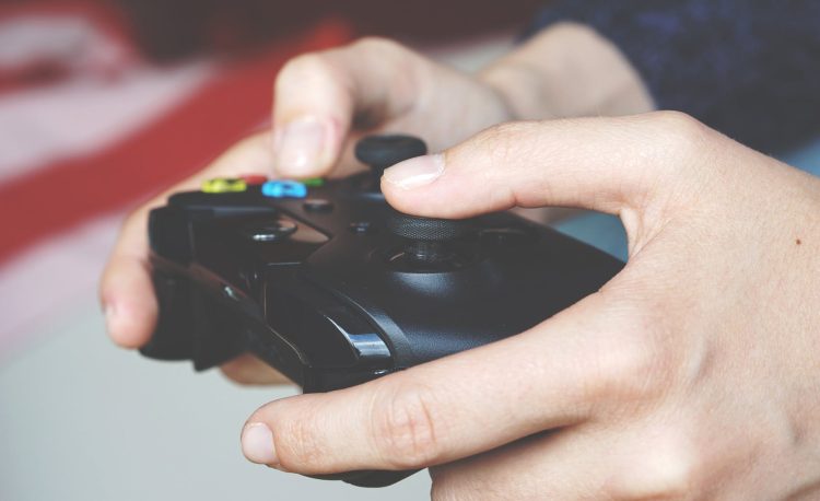 man holding black game controller