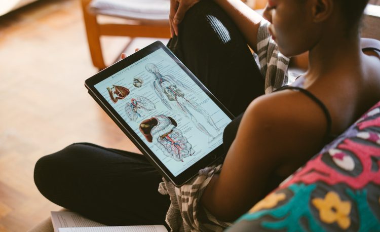 photo of woman studying anatomy