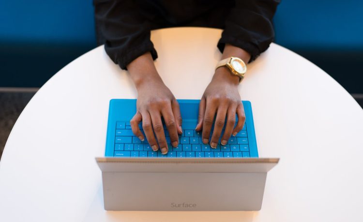 person typing on a laptop