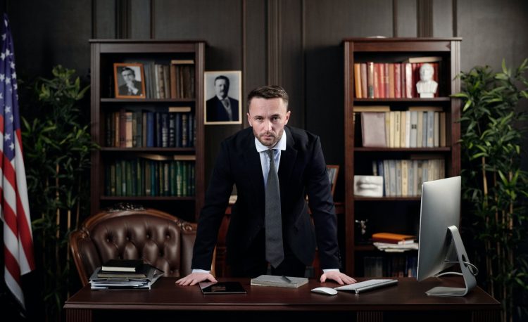 businessman in his office looking at the camera