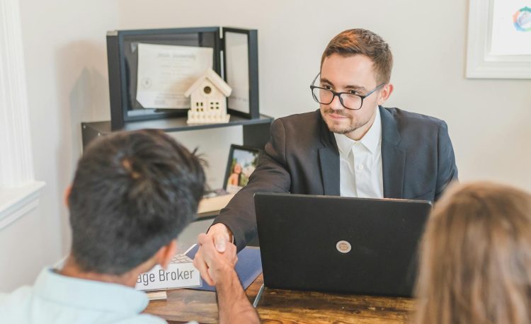 a mortgage broker handshaking with clients