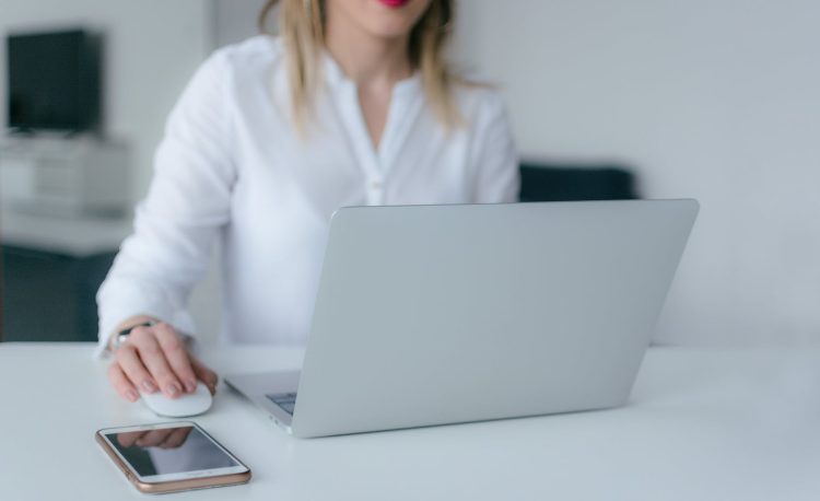 woman using silver laptop