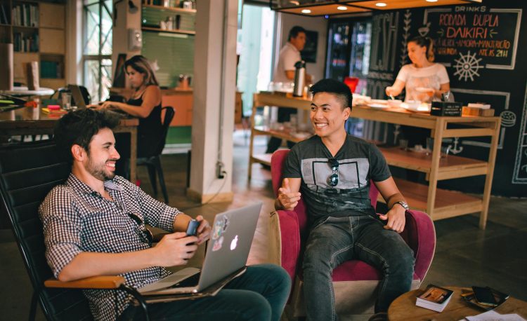 photograph of men having conversation seating on chair