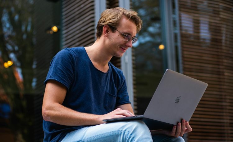 selective focus photo of man using laptop
