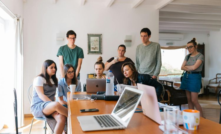 group of people watching on laptop