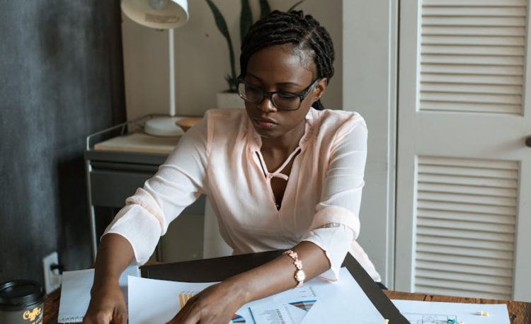 photo of woman working on white paper