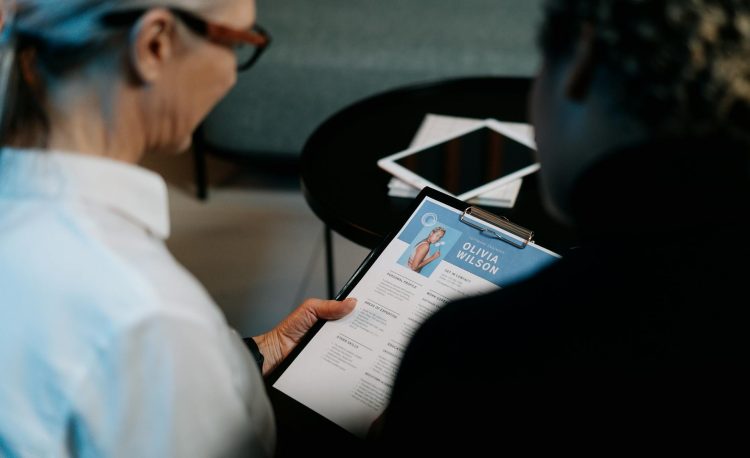 woman holding a clipboard with resume