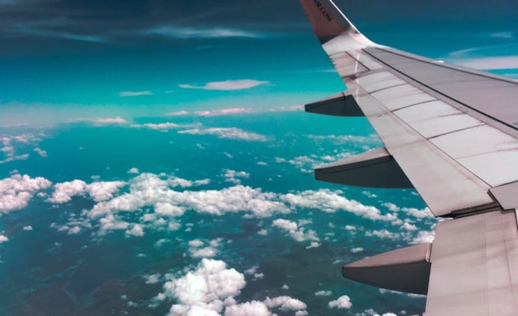 airplane wing above clouds