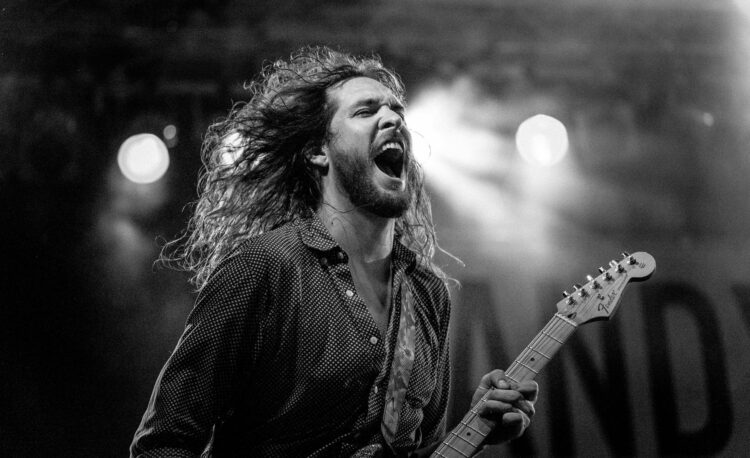 guitarist of greyscale photo
