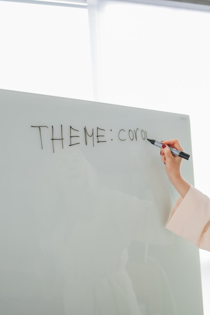 person writing on white board